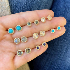 a selection of different sizes and colors of rose cut center stones with diamond haloes