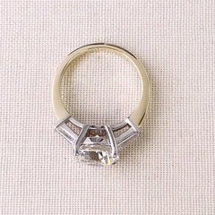 a stunningly gorgeous round center stone, set with white gold prongs on a yellow gold band, bracketed with a beautifully matched pair of tapered baguette diamonds creating an unforgettable once in a lifetime ring. This photo shows the custom made settings for these beautiful stones