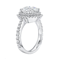 custom made engagement ring with brilliant cut diamond venter, double halo of micropave diamonds and a heavy shank with diamonds shown from the side 