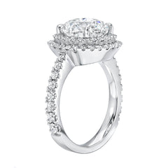 custom made engagement ring with brilliant cut diamond venter, double halo of micropave diamonds and a heavy shank with diamonds shown from the side