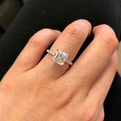 Wow! A gorgeous asscher cut diamond sits atop a band set with round diamonds. This ring makes a huge statement!