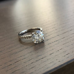 Picture this on your hand today! This beautiful round center stone atop a pave diamond band is a classic timeless choice for any bride modern or traditional.
