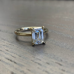 an edgy favorite for a non-traditional bride! This ring features a gorgeous emerald cut all natural diamond with gorgeously modern claw-style prongs.