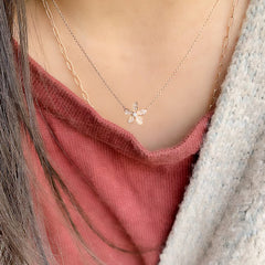 pave plumeira flower necklace in rose gold being worn