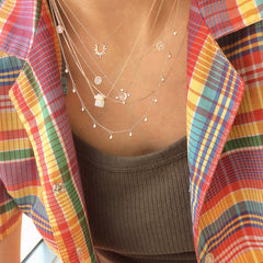 a layered necklace look with motifs, textures, colors and movement