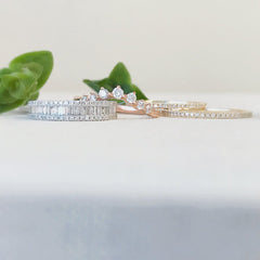 Heirloom baguette and round diamond halfway band worn as part of a stack with other Liven bands