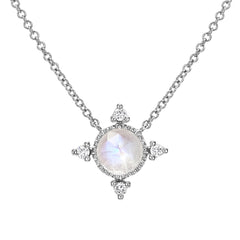 rose cut colored stone in a gold polished bezel with diamonds at the compass points