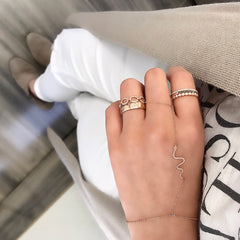 snake hand chain worn with other rings for a fresh boho look