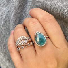 a stack of timeless liven bands paired with a knockout one of a kind paraiba tourmaline ring