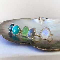 A selection of organic shaped colored stone rings in solid 14k gold with natural diamonds