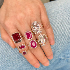 A collection of multiple liven rings in pink and red stones, all in solid 14k gold adorned with natural diamonds