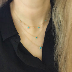 3mm mini turquoise in a 14k gold and diamond halo worn with other turquoise necklaces
