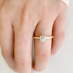 A perfectly formed, elegantly proportioned round diamond, set in four prongs on a classic comfort fit 14k yellow gold band worn on hand