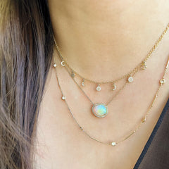 danity 14k gold chain featuring dangling discs and mini crescent moons to encapsulate the phases of the moon