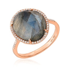 Rose gold ring with a large labradorite stone and micropave diamonds on a white background