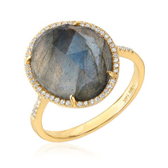 Gold ring with a large labradorite stone and micropave diamonds on a white background