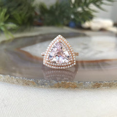 More than diamonds! This double haloed ring features a trillion-cut morganite, hand-selected for cut and color, and set on a custom band for a one-in-a-million bride.