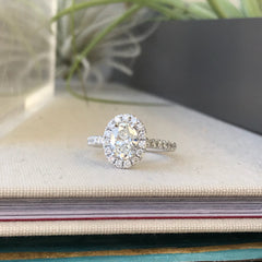 accentuate a dainty center stone with a halo of all-natural, micropave diamonds in stunning 18k white gold!