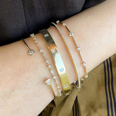 a selection of rich gold and dimaond bangles and bracelets