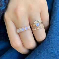 oval moonstones in a halfway band with subtle prongs for maximum impact worn with other rings