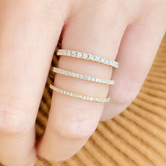 diamond eternity band stacked with other liven rings