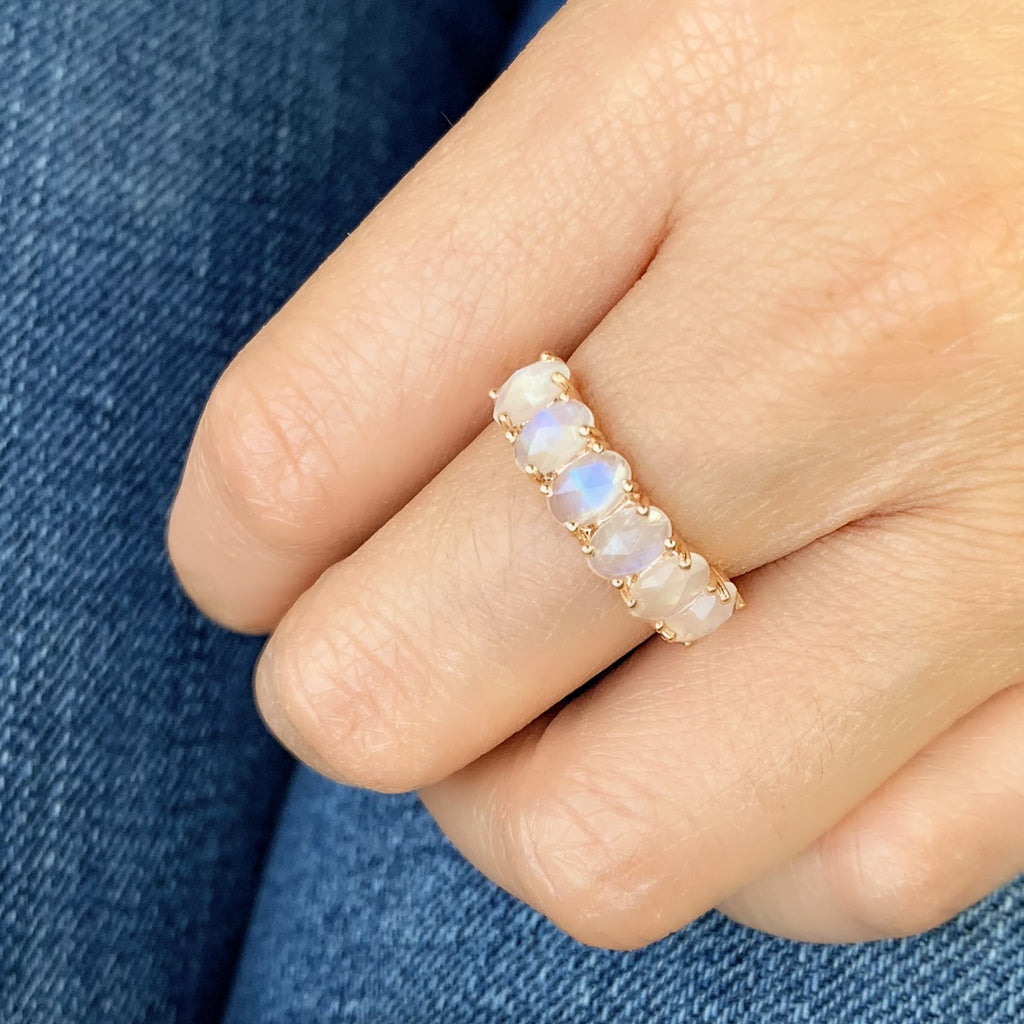 oval moonstones in a halfway band with subtle prongs for maximum impact