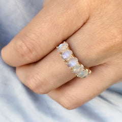oval moonstones in a halfway band with subtle prongs for maximum impact