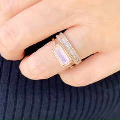 rose gold rainbow moonstone ring stacked with heirloom halfway band