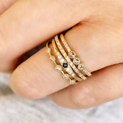 stack of liven rings featuring petite vintage style ring with diamonds and sapphire
