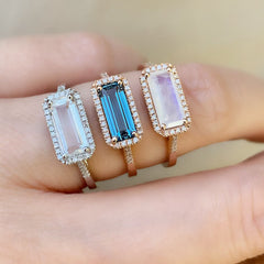 east-west emerald cut colored stone rings