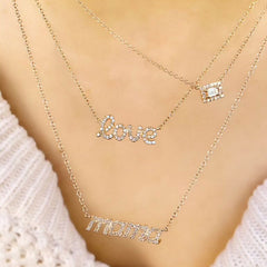 love script necklace layered with other liven pieces