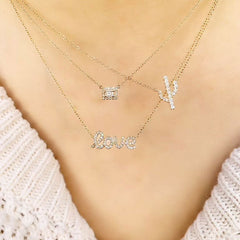 love script necklace layered with other liven pieces