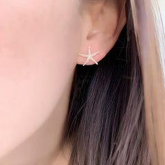 Starfish earrings on ear