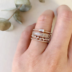 heirloom baguette diamond halfway band stacked with other liven rings