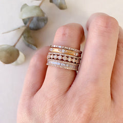 diamond eternity band stacked with other liven rings
