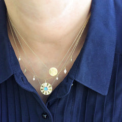 alternating dangling diamond kites necklace in yellow gold layered with other liven necklaces