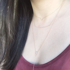 triangle necklace layered with other necklaces