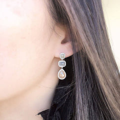 one of a kind rustic diamond earrings on ear