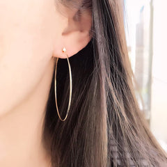 50mm Souli hoops with diamonds at the top in 14k yellow gold on ear