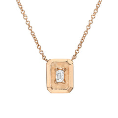 oblong high polish and textured finish gold pendant with baguette cut diamond in the center