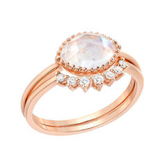 two ring set consisting of a bezel set marquise shaped rainbow moonstone, with a matching arch shaped ring of diamonds