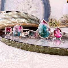 a selection of one of a kind rings with brightly colored center stones