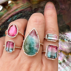 a selection of rings with brightly colored center stones