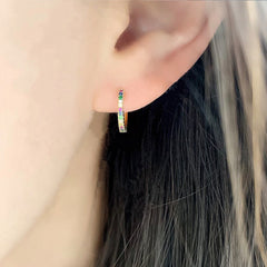rainbow sapphire and diamond huggies on ear